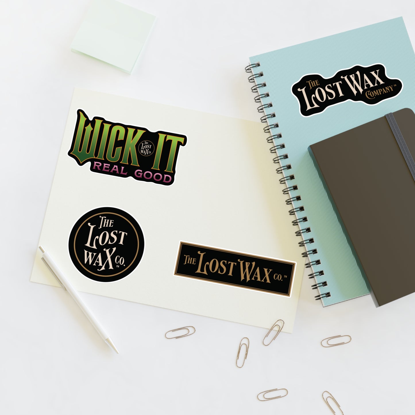 Notebooks with 'The Lost Wax Company' branding on a white background
