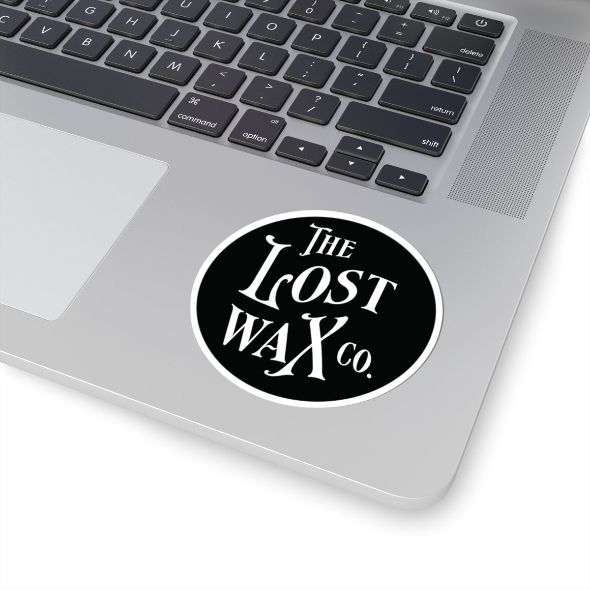 Laptop with a 'The Lost Wax Co.' sticker on the palm rest area