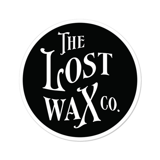 Round sticker with 'The Lost Wax Co.' text on a black background