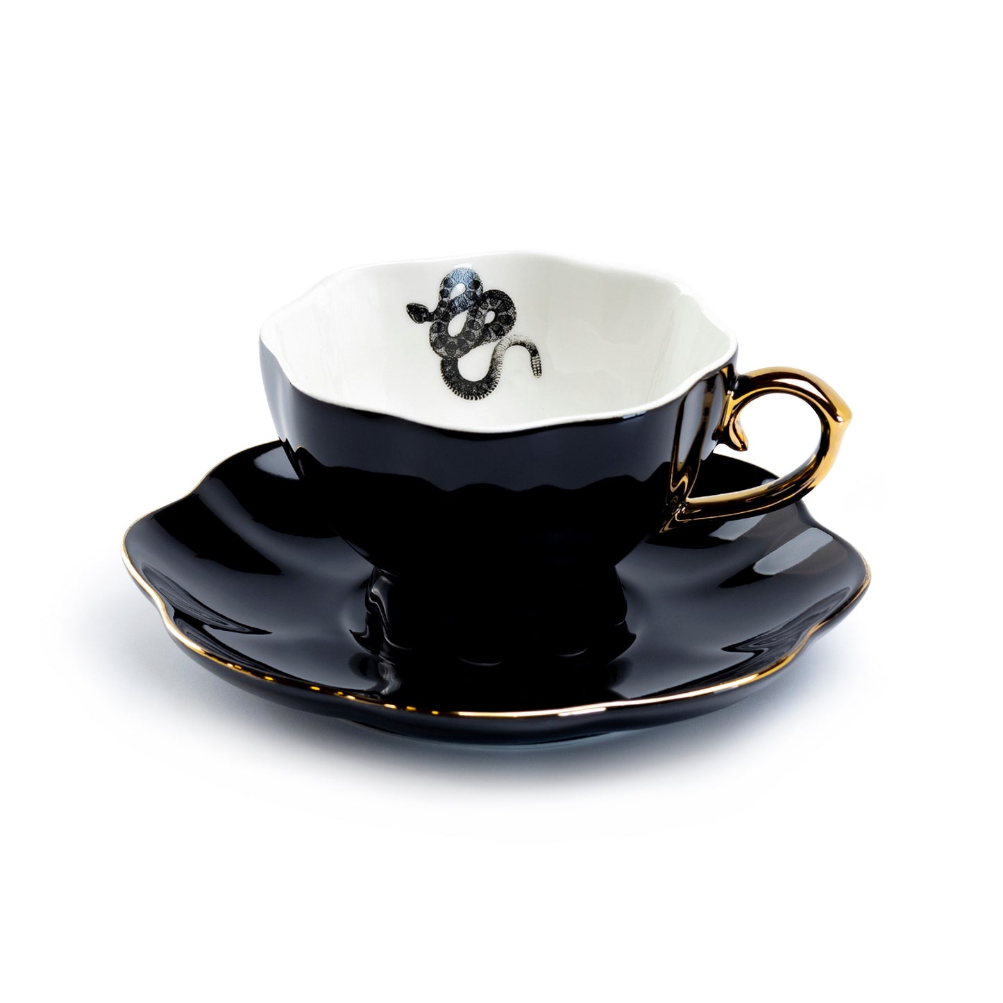 Black teacup and saucer with gold handle and decorative snake on a white background