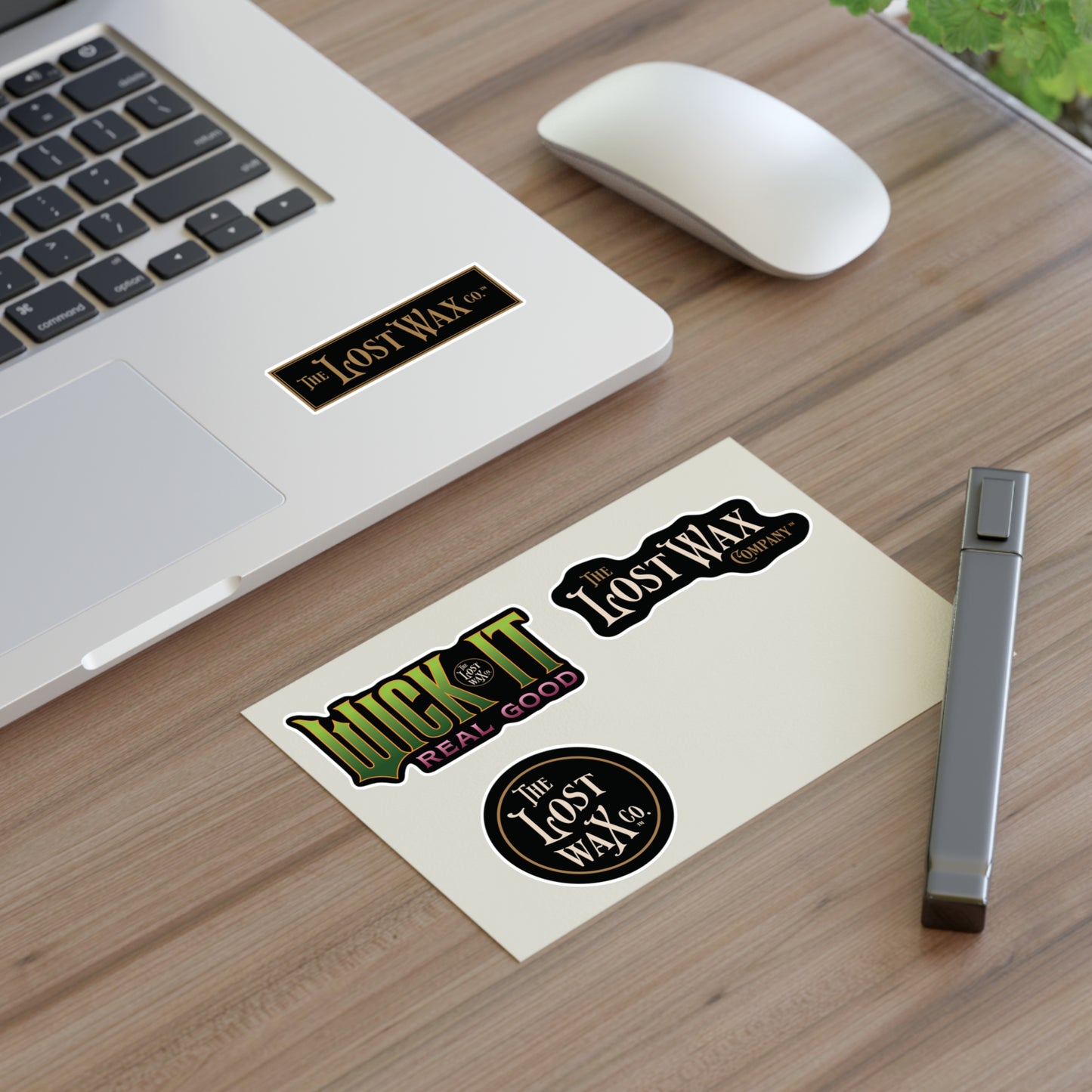 Stickers on a desk with a laptop and mouse