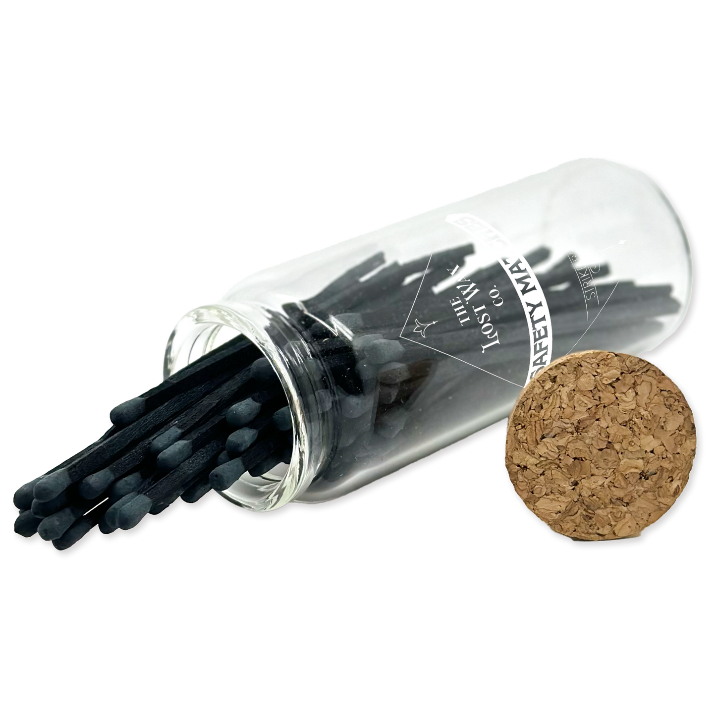 Clear glass tube with black safety matches and cork lid on a white background