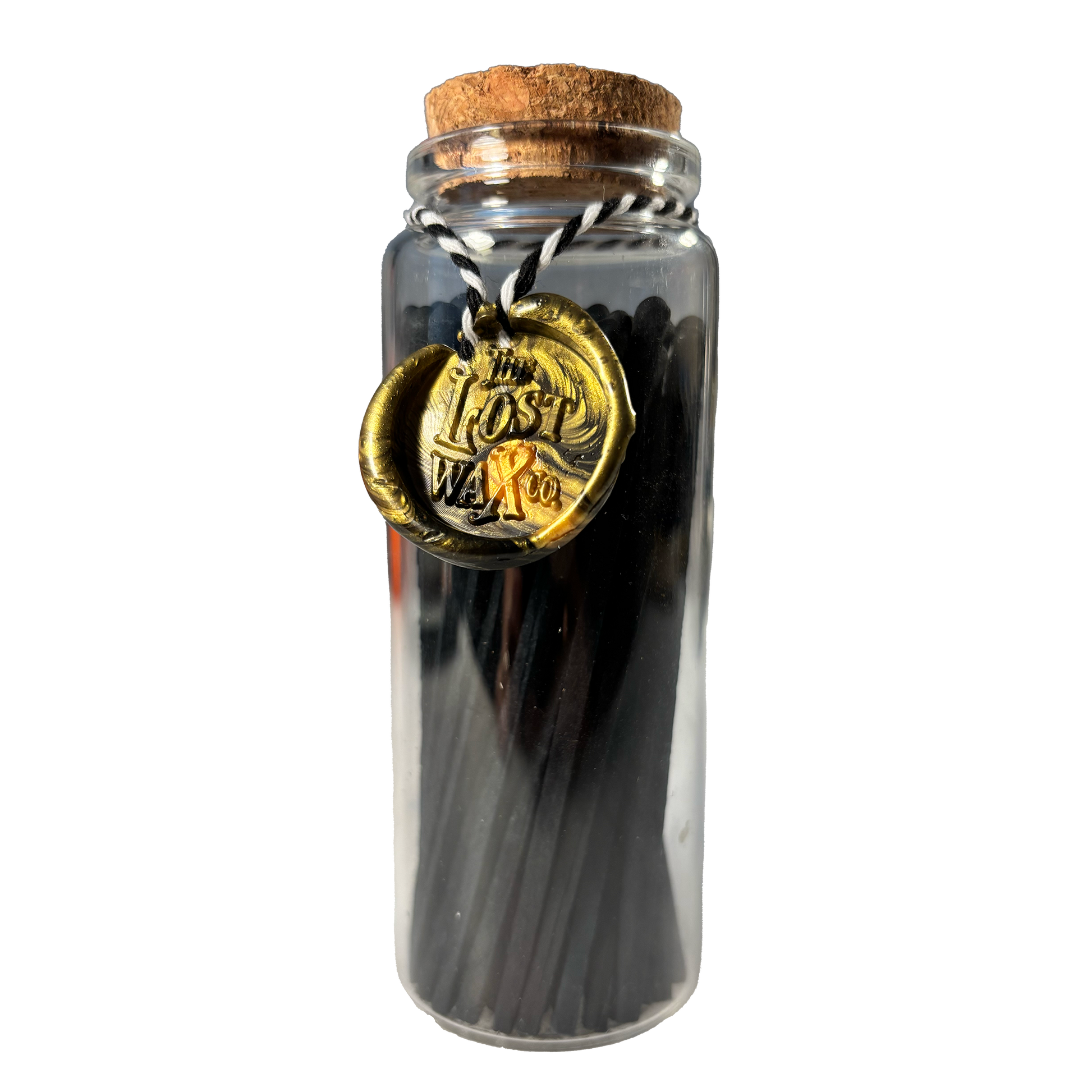 Glass jar with cork lid containing black safety matches and a gold seal labeled 'The Lost Weft Co.' on a white background.