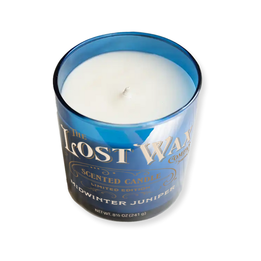 Midwinter Juniper Candle in a blue container with 'The Lost Wax Company' branding on a white background
