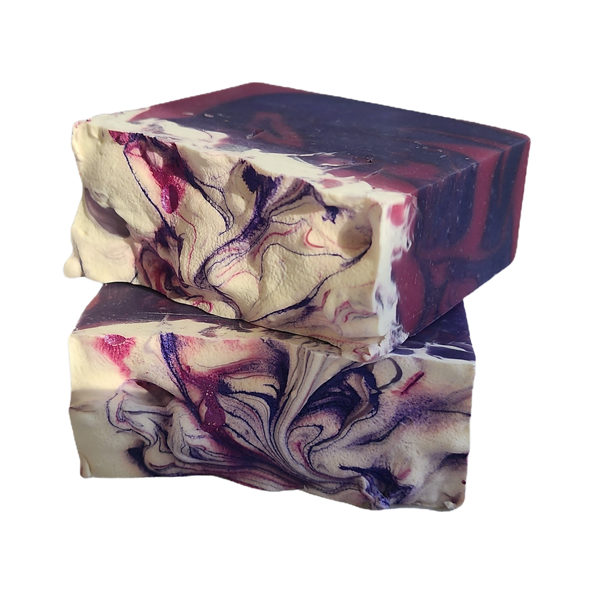 Two stacked rectangular bars of handmade soap with a marbled swirl pattern of cream, deep purple, and red, isolated on a white background.