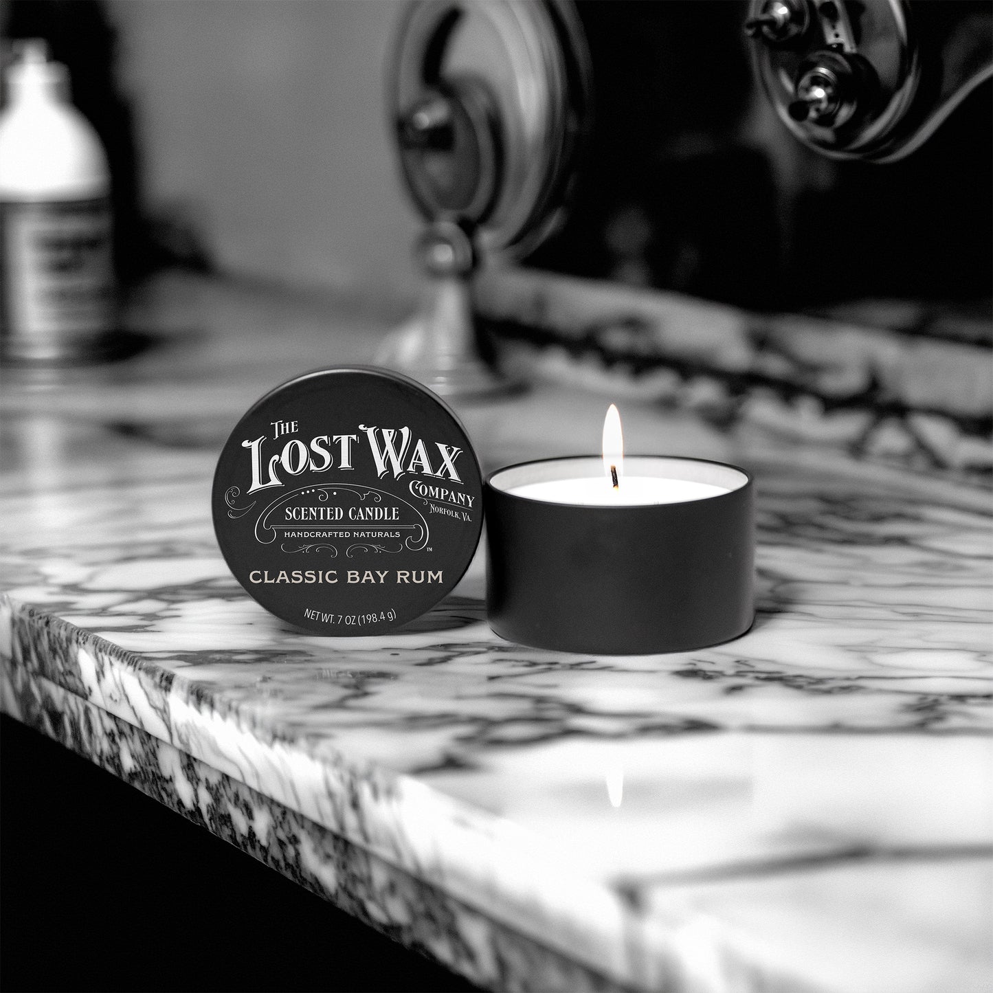 Lost Wax Company candle on a marble surface with vintage background