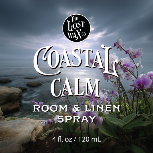 Label for Coastal Calm Room & Linen Spray, with The Lost Wax Co. brand and background image of a seashore with pink and white orchids.