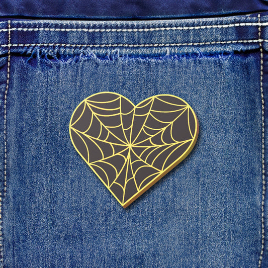 Heart-shaped spider web design on a denim background