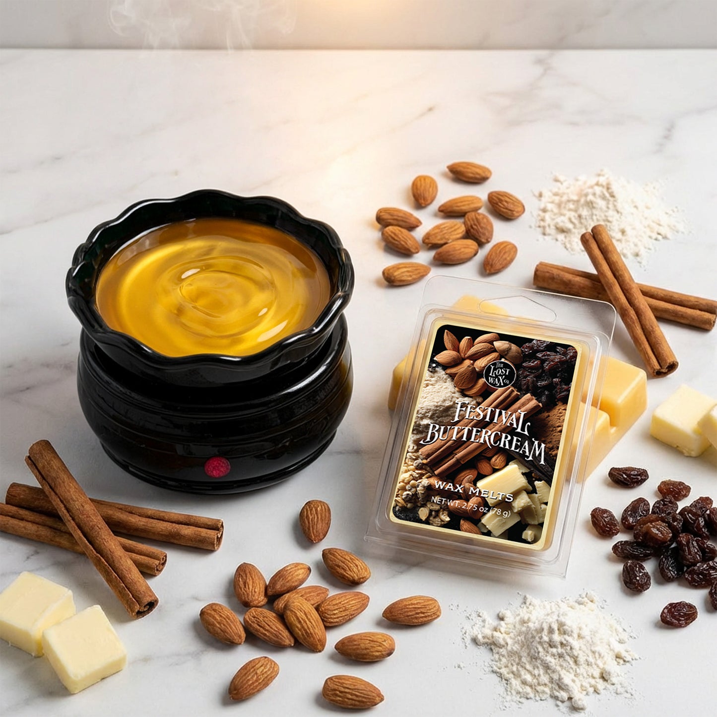 Black wax warmer surrounded by almonds, cinnamon sticks, and a package of Festival Buttercream wax melts on a white marble surface.