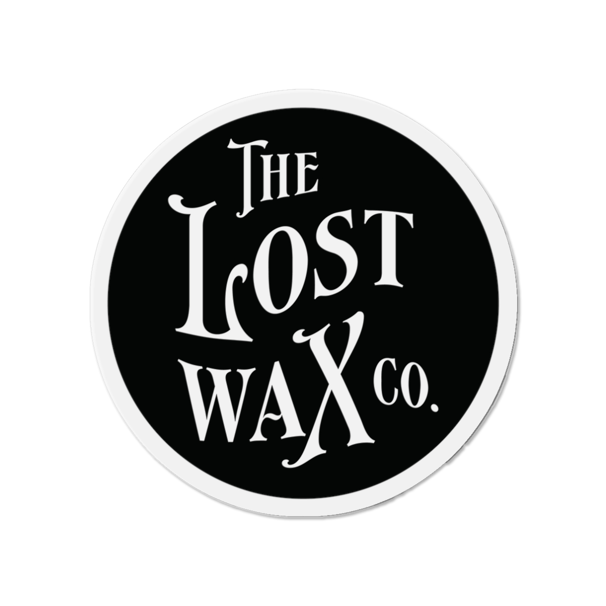 Round magnet with 'The Lost Wax Co.' text on a black background