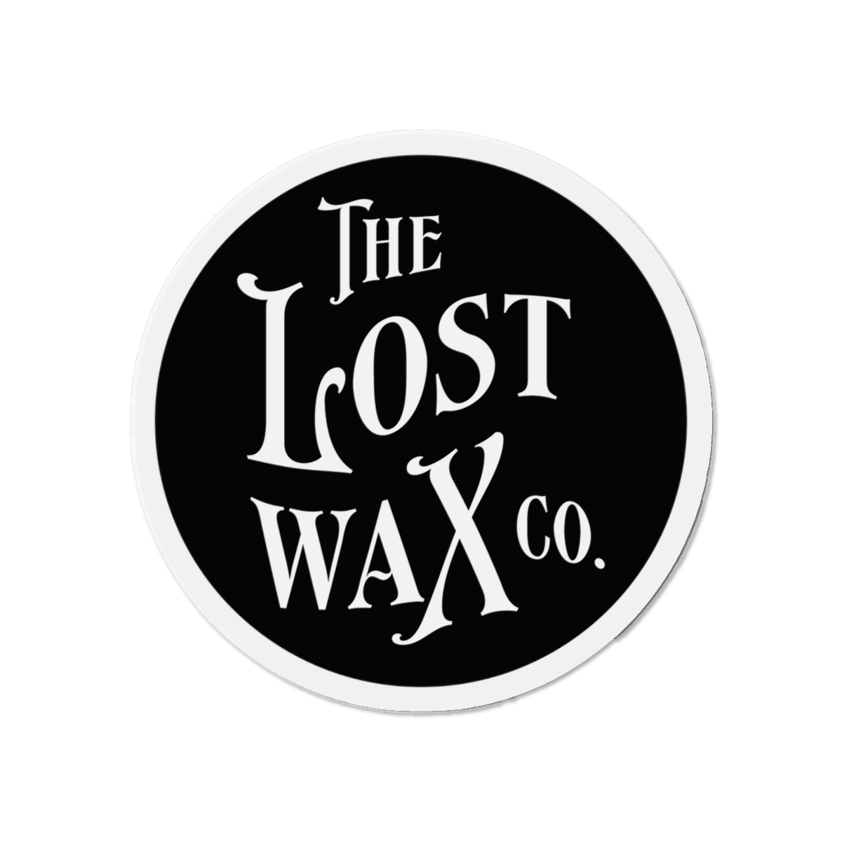 Round magnet with 'The Lost Wax Co.' text on a black background