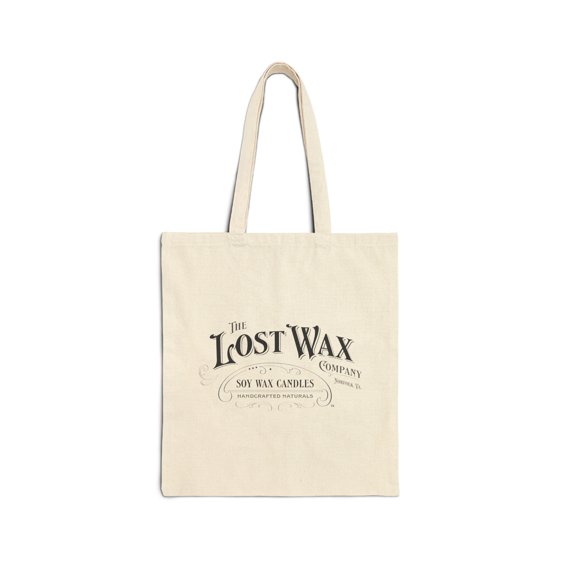 Beige tote bag with 'The Lost Wax Company' logo on a white background