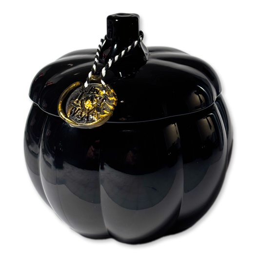 Black pumpkin-shaped container with a gold emblem on a white background