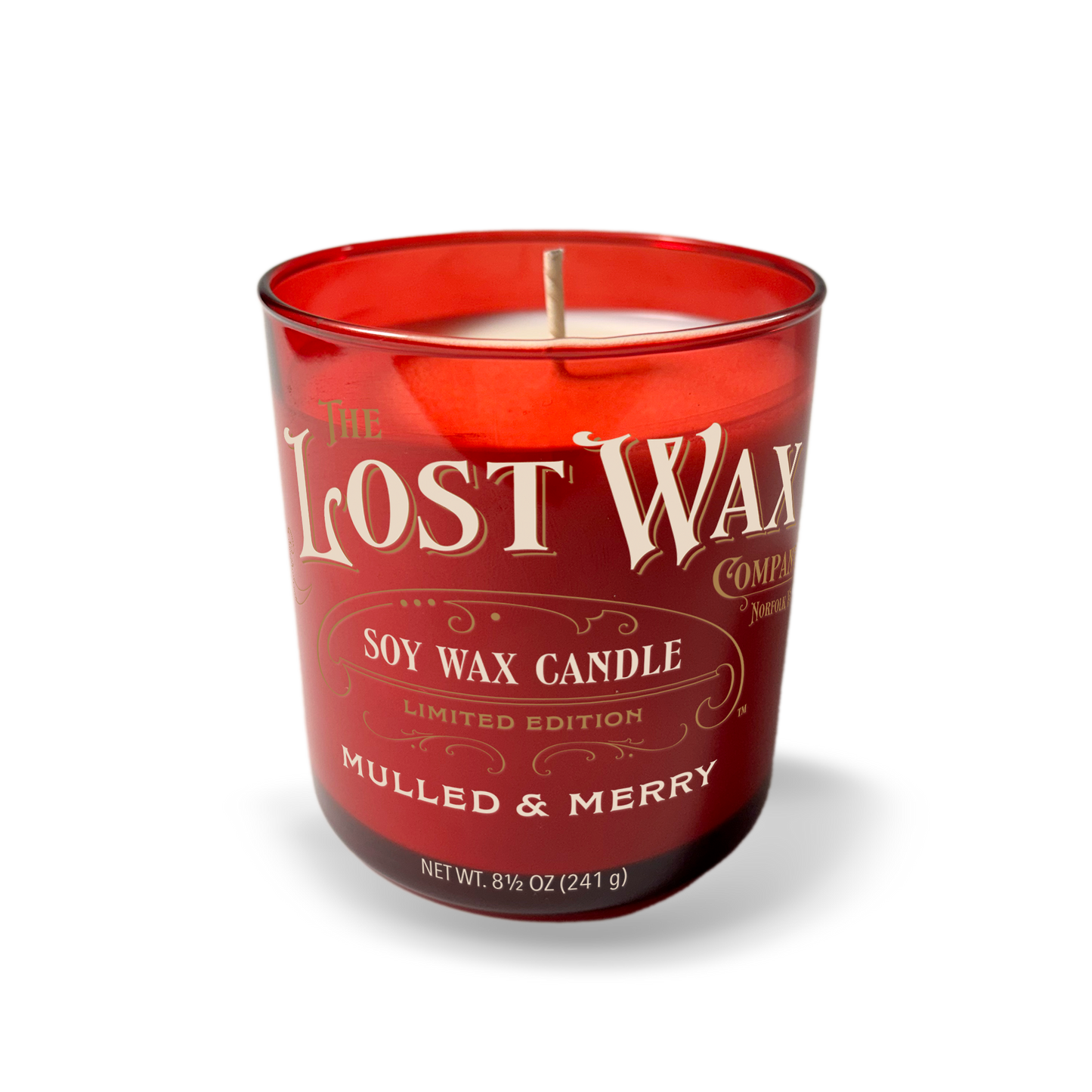 Red candle with 'The Lost Wax Company' branding on a white background