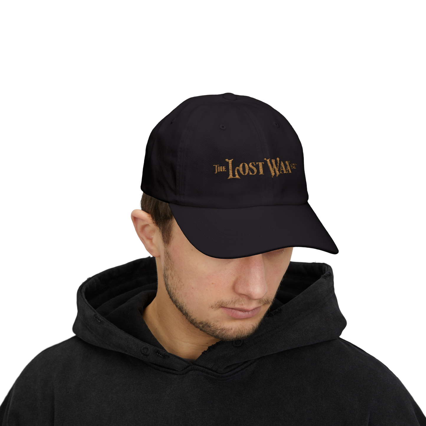 Person wearing a black cap with 'The Lost Wax' logo on a white background