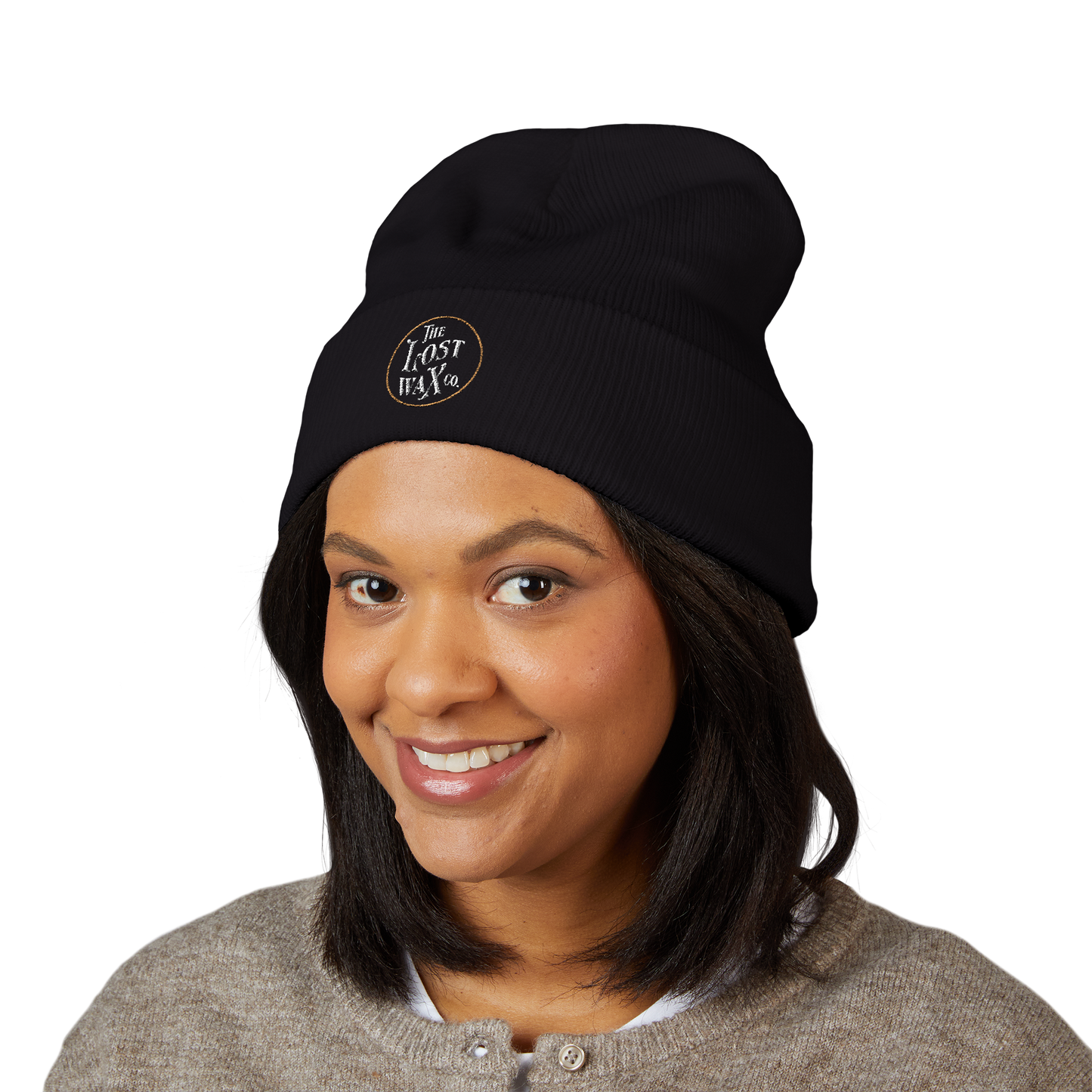 Person wearing a black beanie with a logo on a white background