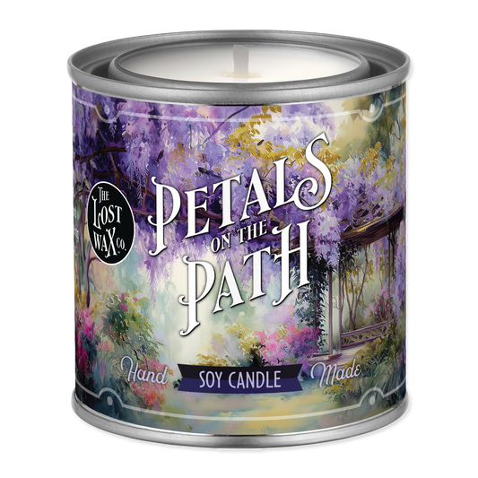 Candle in a decorative tin with 'Petals on the Path' design and 'The Lost Wax Co.' branding.