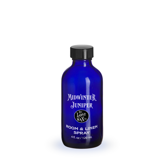 Blue bottle labeled 'Midwinter Juniper' on a white background