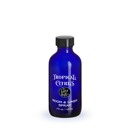 Blue bottle with a label featuring a tropical scene on a white background