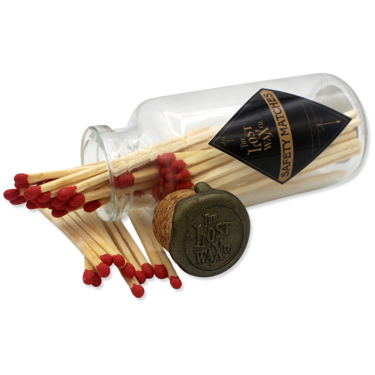 Glass jar with cork lid containing red safety matches branded 'The Lost Wax Co'.