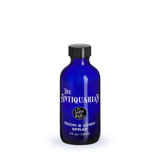 Blue bottle of room and linen spray with a label on a white background