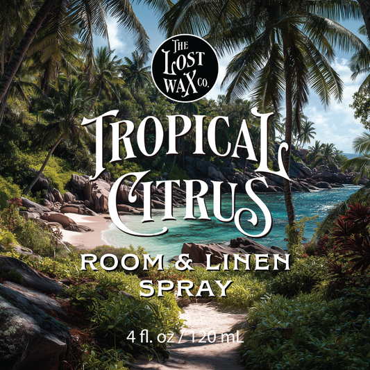 Tropical scenery with palm trees and ocean, featuring 'The Lost Wax Co. Tropical Citrus' room & linen spray advertisement.
