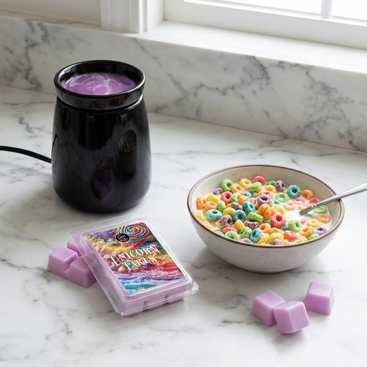 Black wax warmer with colorful wax melts, a bowl of cereal, and a spoon on a marble surface.