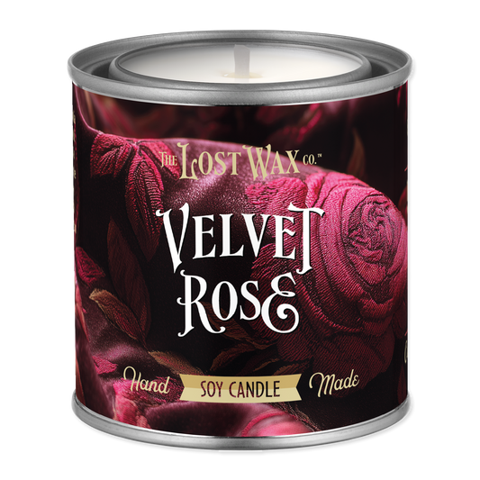 Candle in a decorative tin labeled 'Velvet Rose' from The Lost Wax Co.