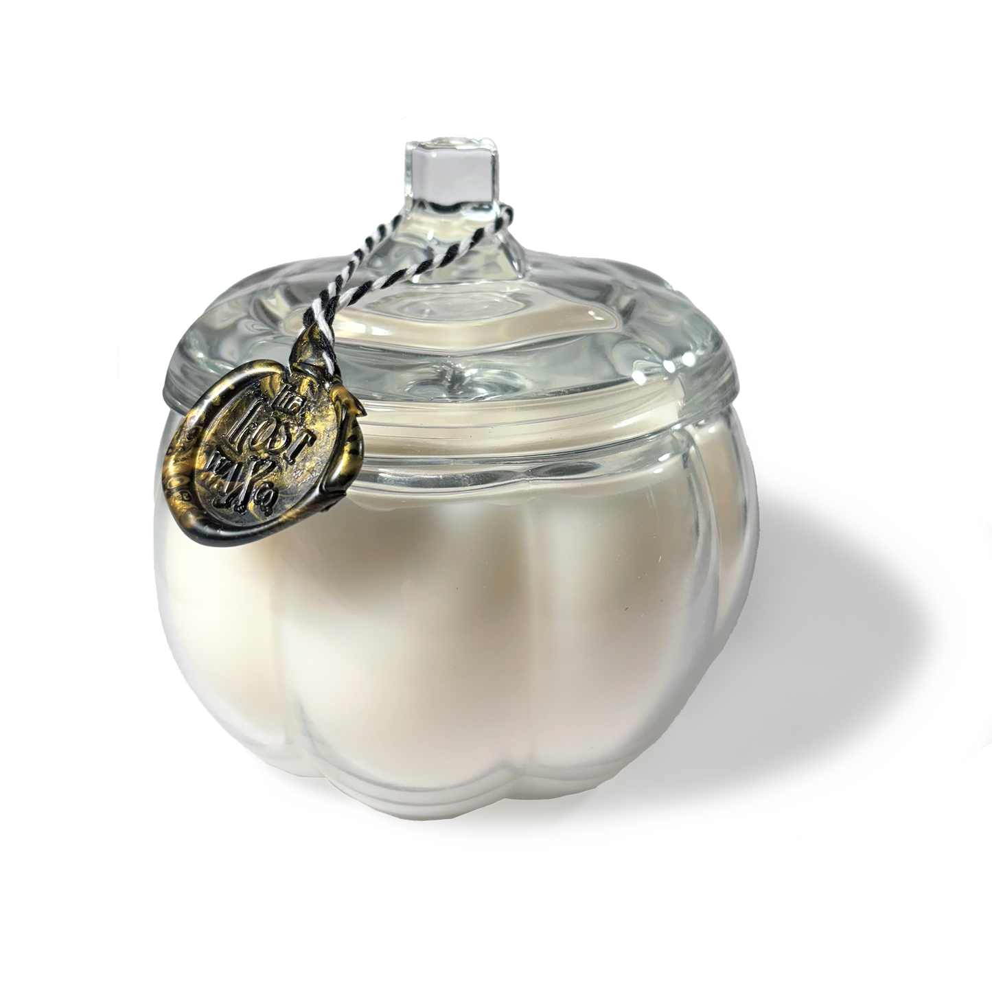 White ceramic pumpkin-shaped container with a clear glass lid on a white background