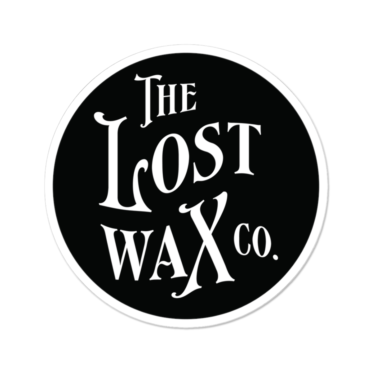 Round sticker with 'The Lost Wax Co.' text on a black background