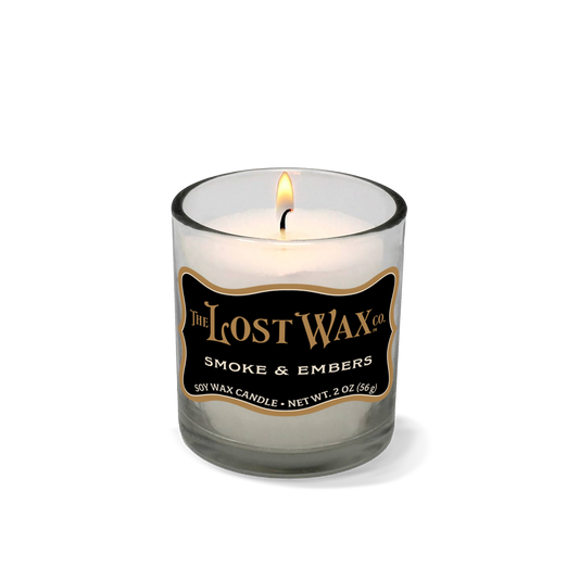 Smoke & Embers Votive Candle in a glass jar with 'The Lost Wax Company' branding on a white background