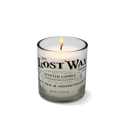 Sweet Tea & Honeysuckle scented candle in a glass container with 'The Lost Wax Company' branding on a white background.