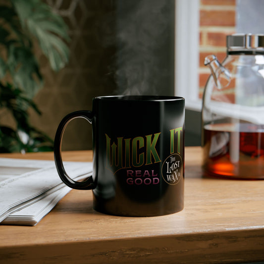 Black mug with text on a wooden table with a blurred background