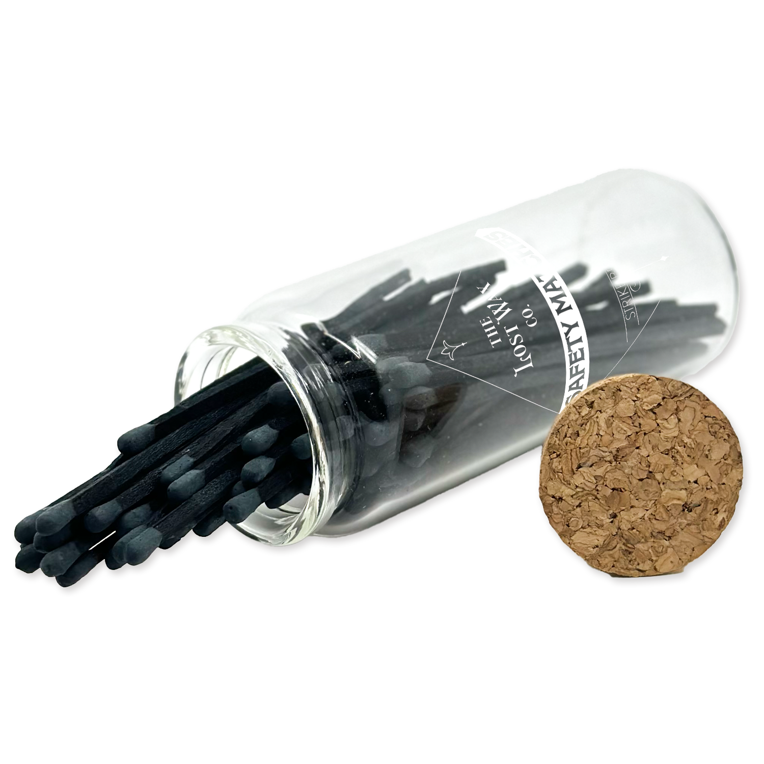 Clear glass tube with black safety matches and cork lid on a white background
