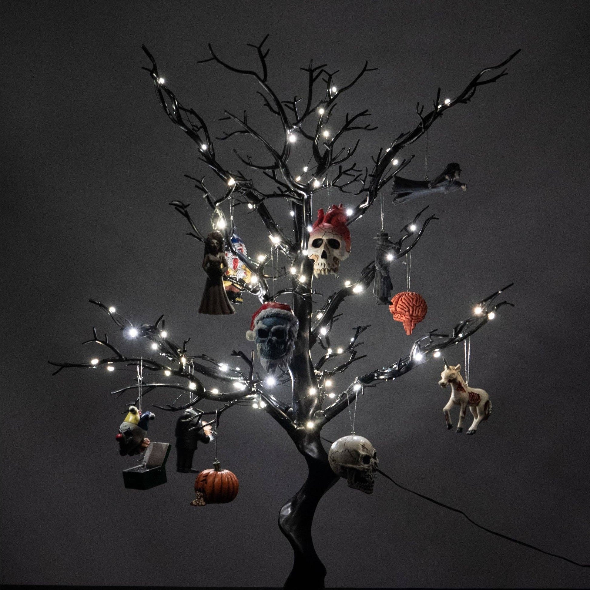 Decorative Halloween tree with lights and small ornaments on a dark background