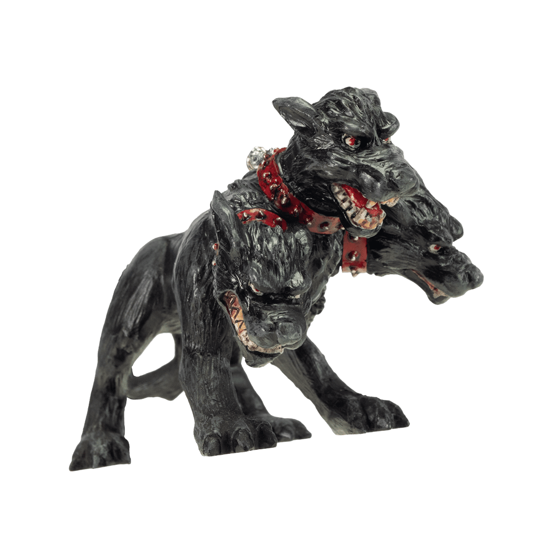 A black multi-headed dog ornament, likely a three-headed hound, with textured fur, red eyes, a red collar with silver studs, and an open mouth showing sharp teeth, isolated on a white background.