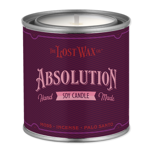 Purple candle container labeled 'Absolution' by The Lost Wax Co. on a white background