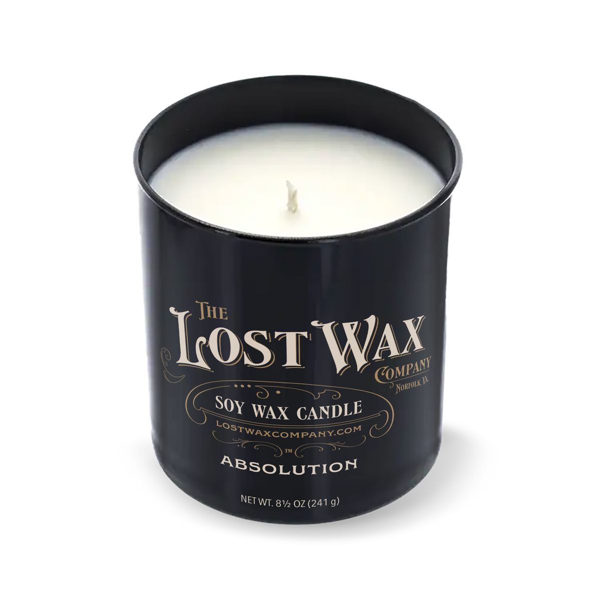 A black cylindrical scented candle jar with a matching lid leaning against it on a white background. The label reads 'The Lost Wax Company' and 'Absolution'.