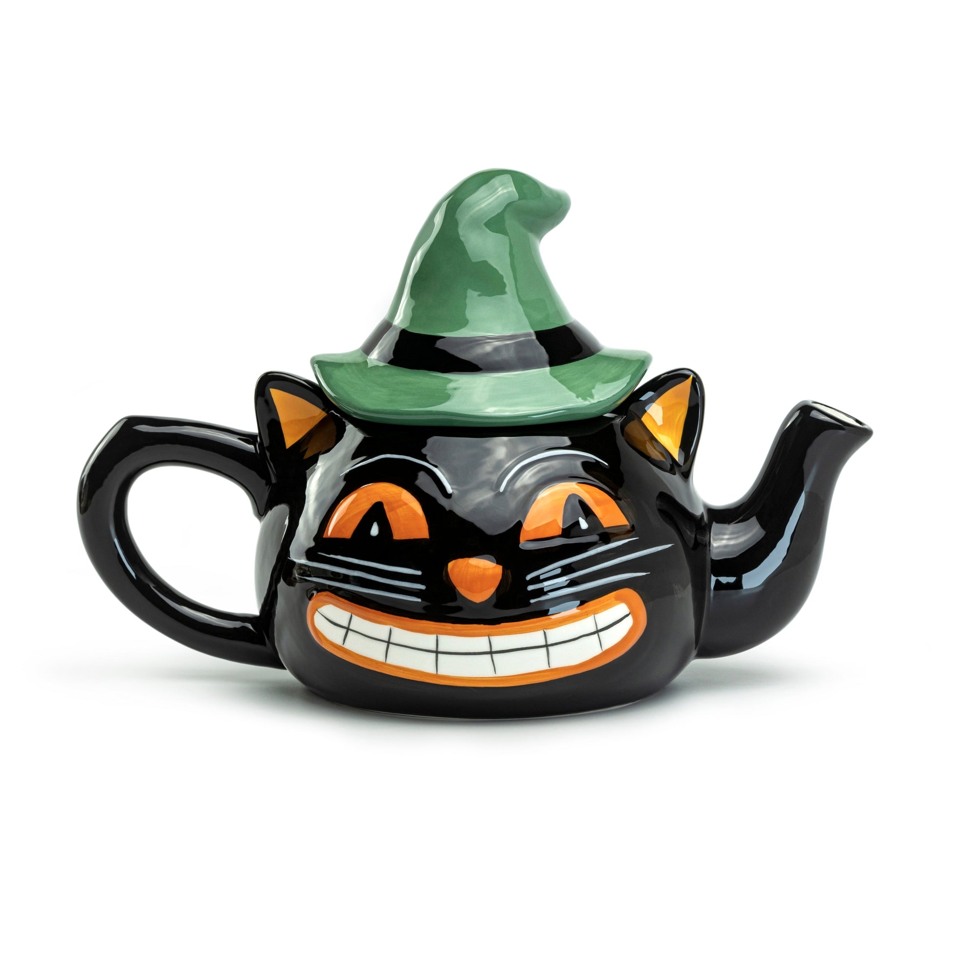 A black ceramic teapot shaped like a cat's head wearing a green witch hat, with orange and white facial details, shown on a plain white background.
