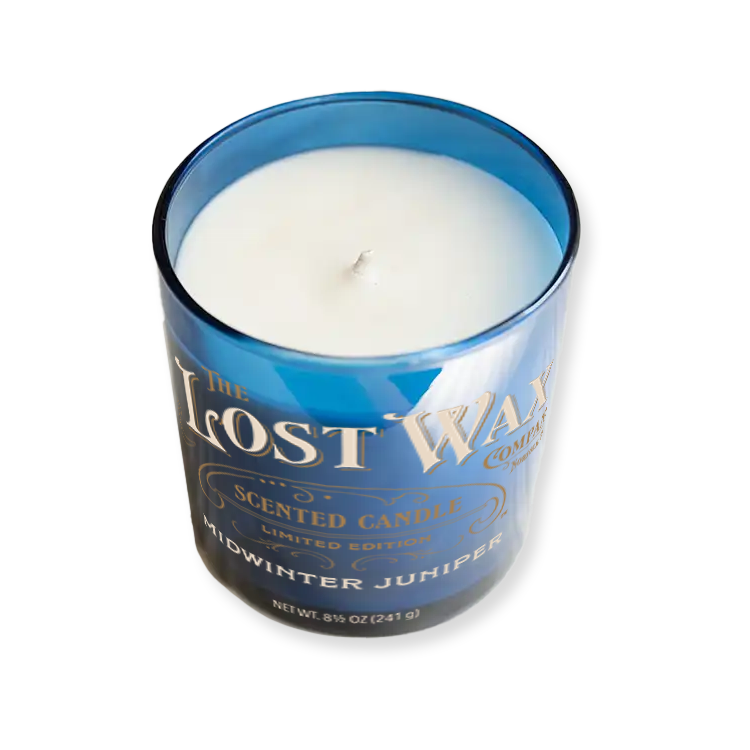 Midwinter Juniper Candle in a blue container with 'The Lost Wax Company' branding on a white background