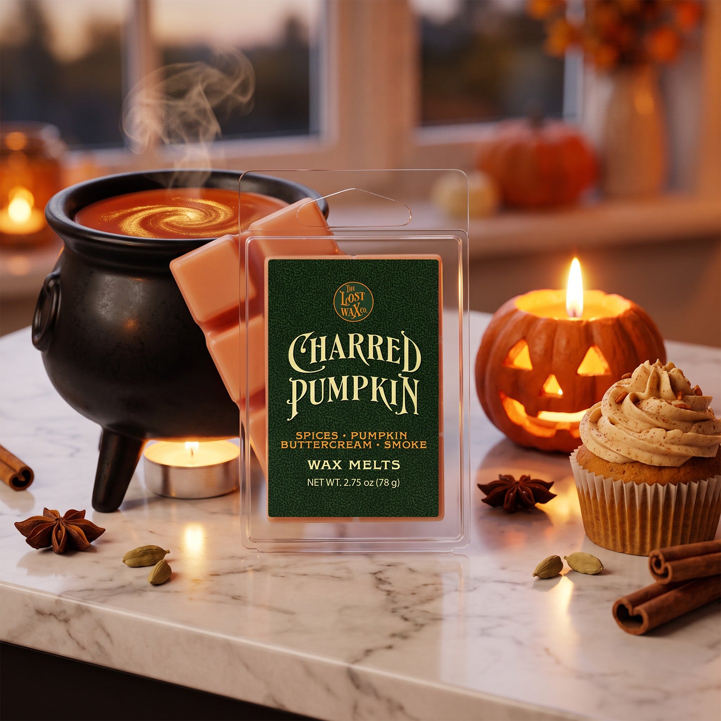 A package of 'Charred Pumpkin' wax melts stands on a marble countertop in a cozy Halloween-themed setting, surrounded by a steaming cauldron, a lit jack-o'-lantern candle, and a pumpkin spice cupcake.