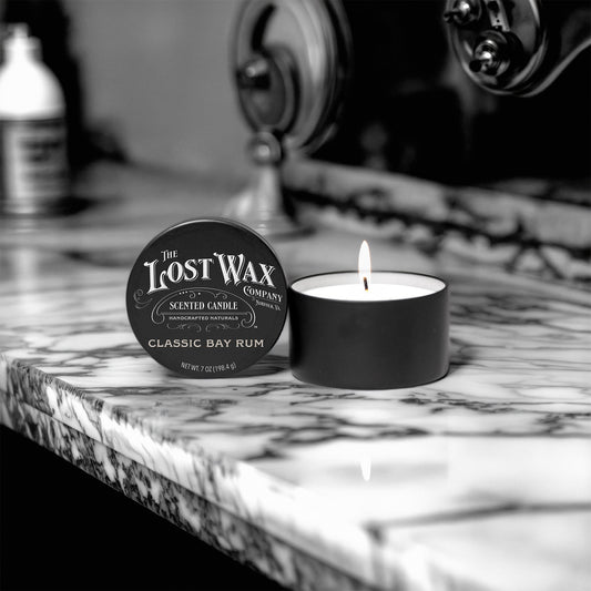 Lost Wax Company candle on a marble surface with vintage background