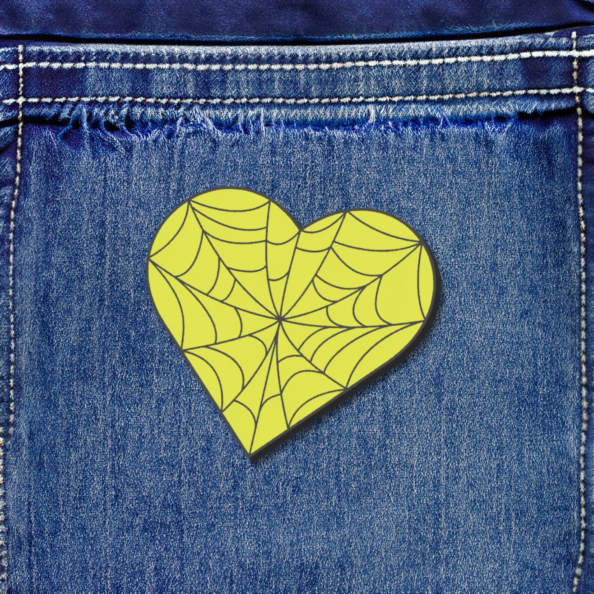 Heart-shaped spider web design on blue denim fabric