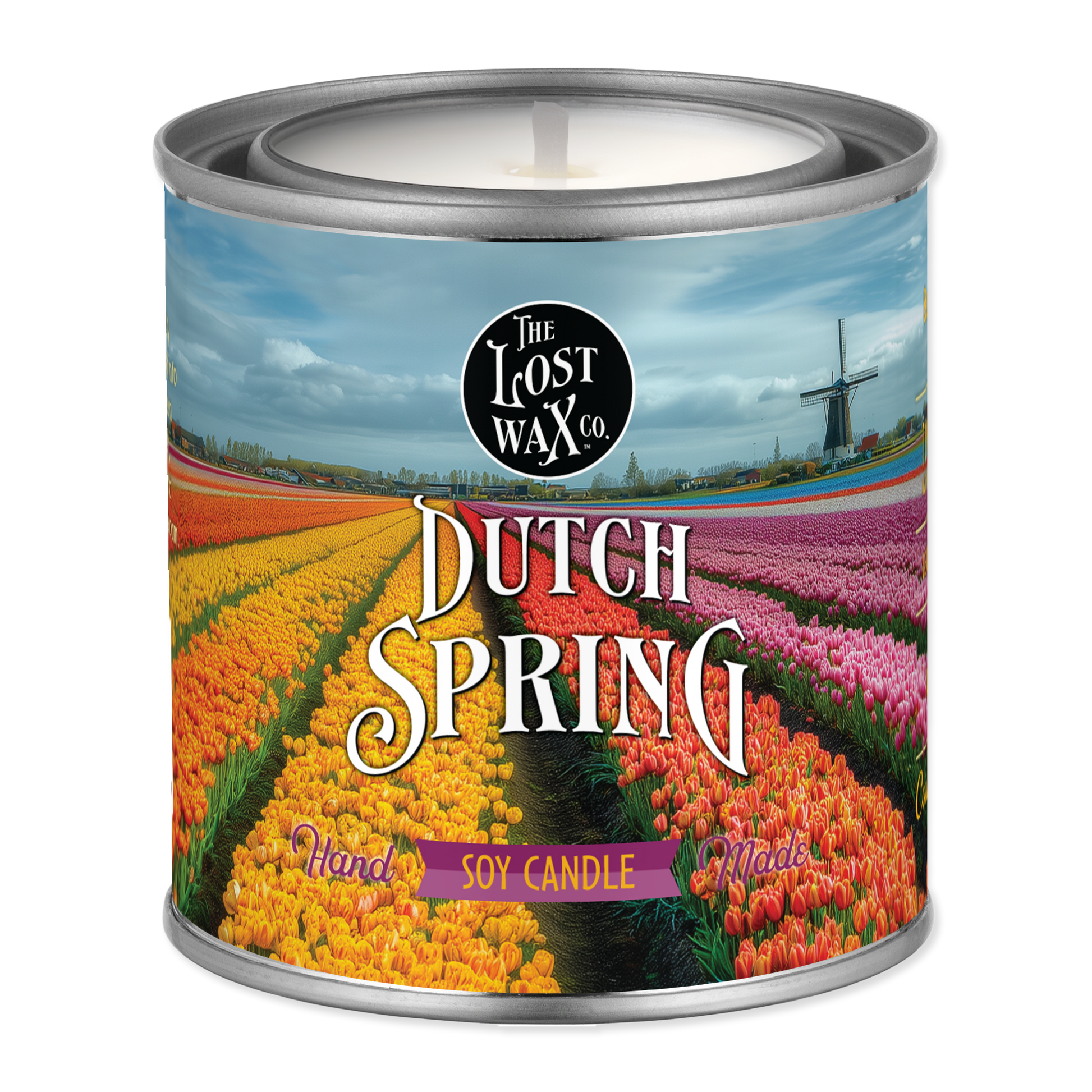 Candle in a can labeled 'Dutch Spring' with a scenic design on the label.
