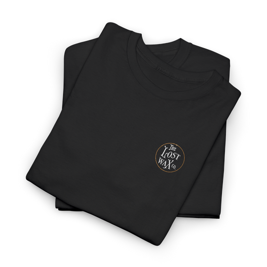 Folded black shirt with 'The Lost Wax Co' logo on a white background
