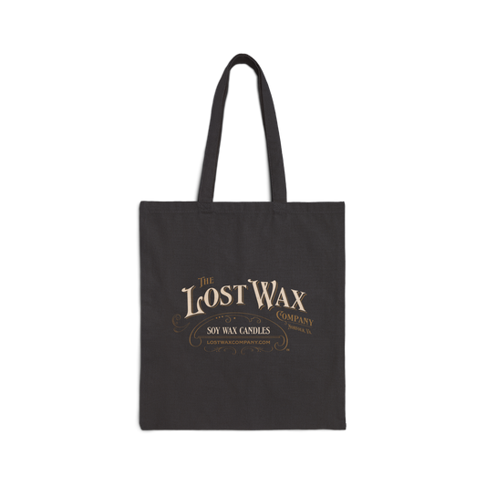 Black tote bag with 'The Lost Wax Company' logo on a white background
