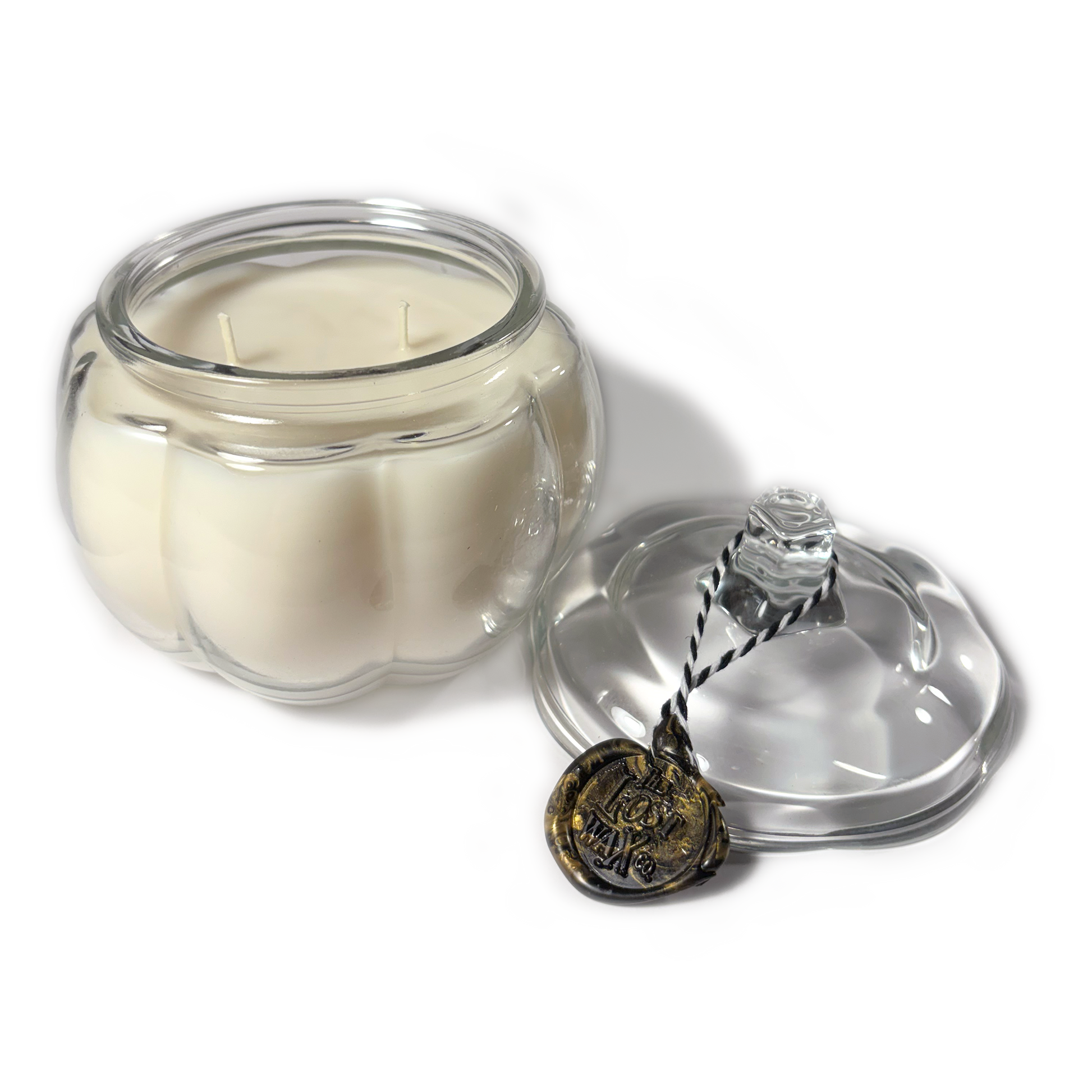 Candle in a glass jar with a decorative lid on a white background