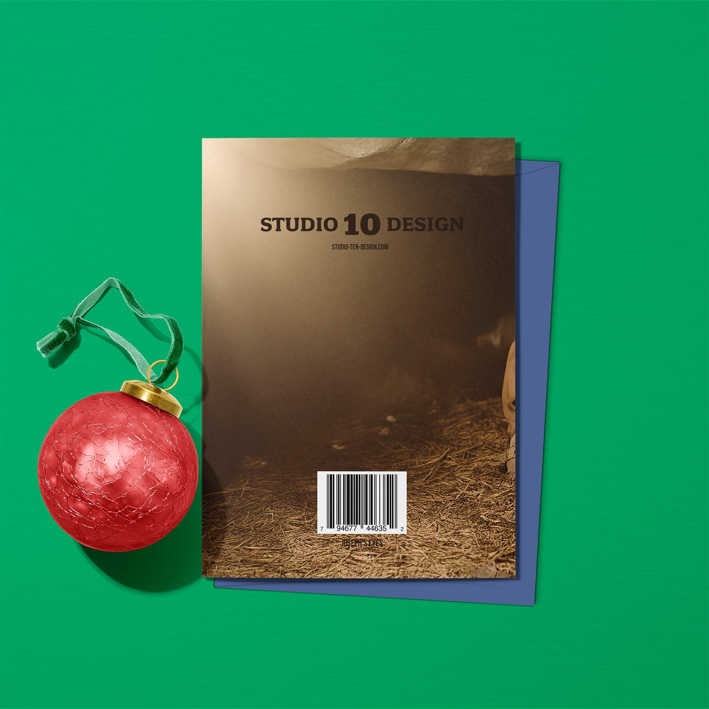 Brown card with 'Studio 10 Design' text on a green background with a red ornament and blue envelope.