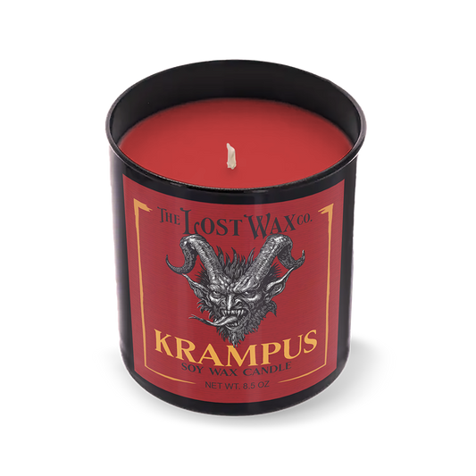 Red candle in a black container with 'Krampus' label on a white background