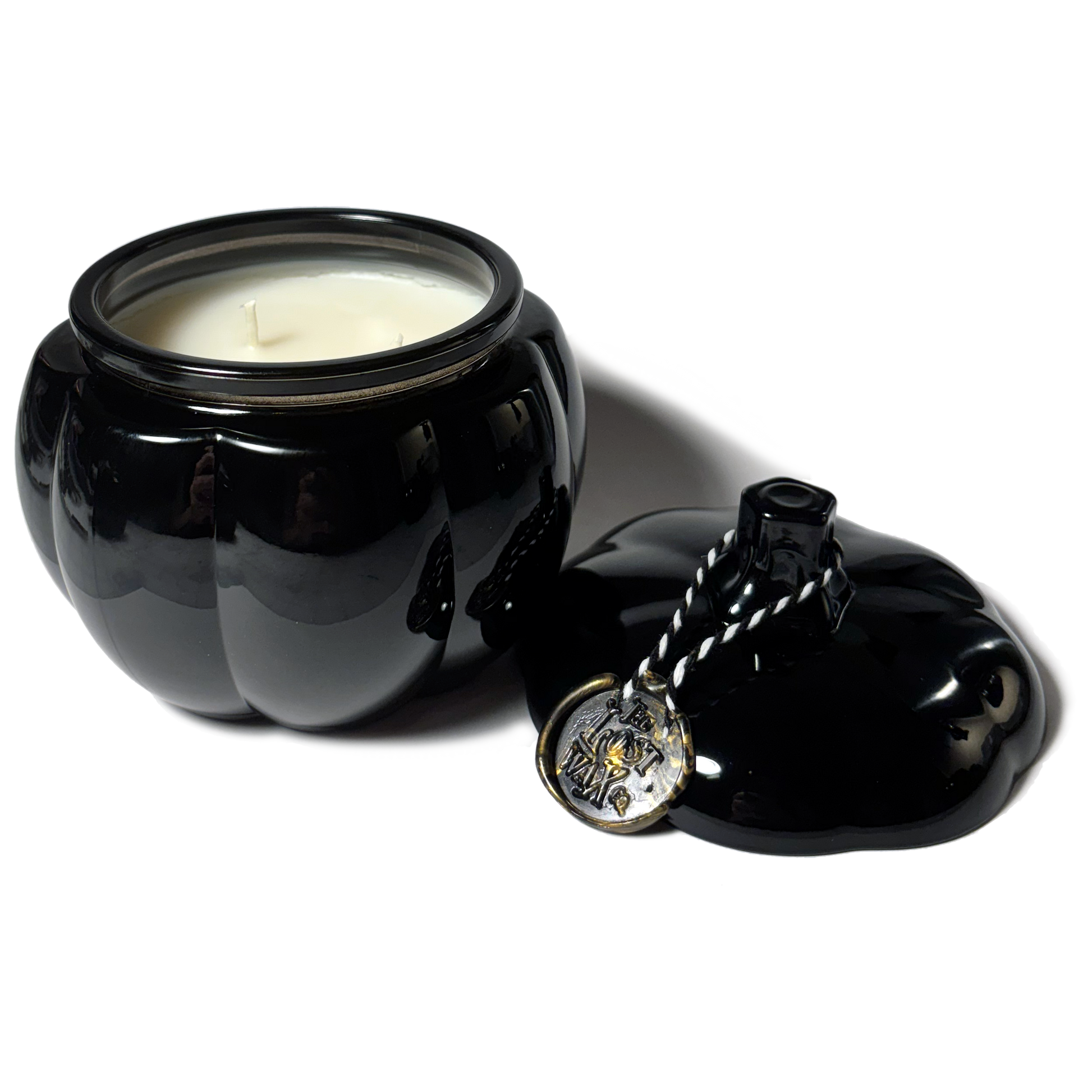 Black glasspumkin-shaped jar with a candle inside and a decorative lid on a white background